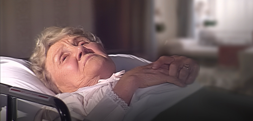 Elder woman rests in bed