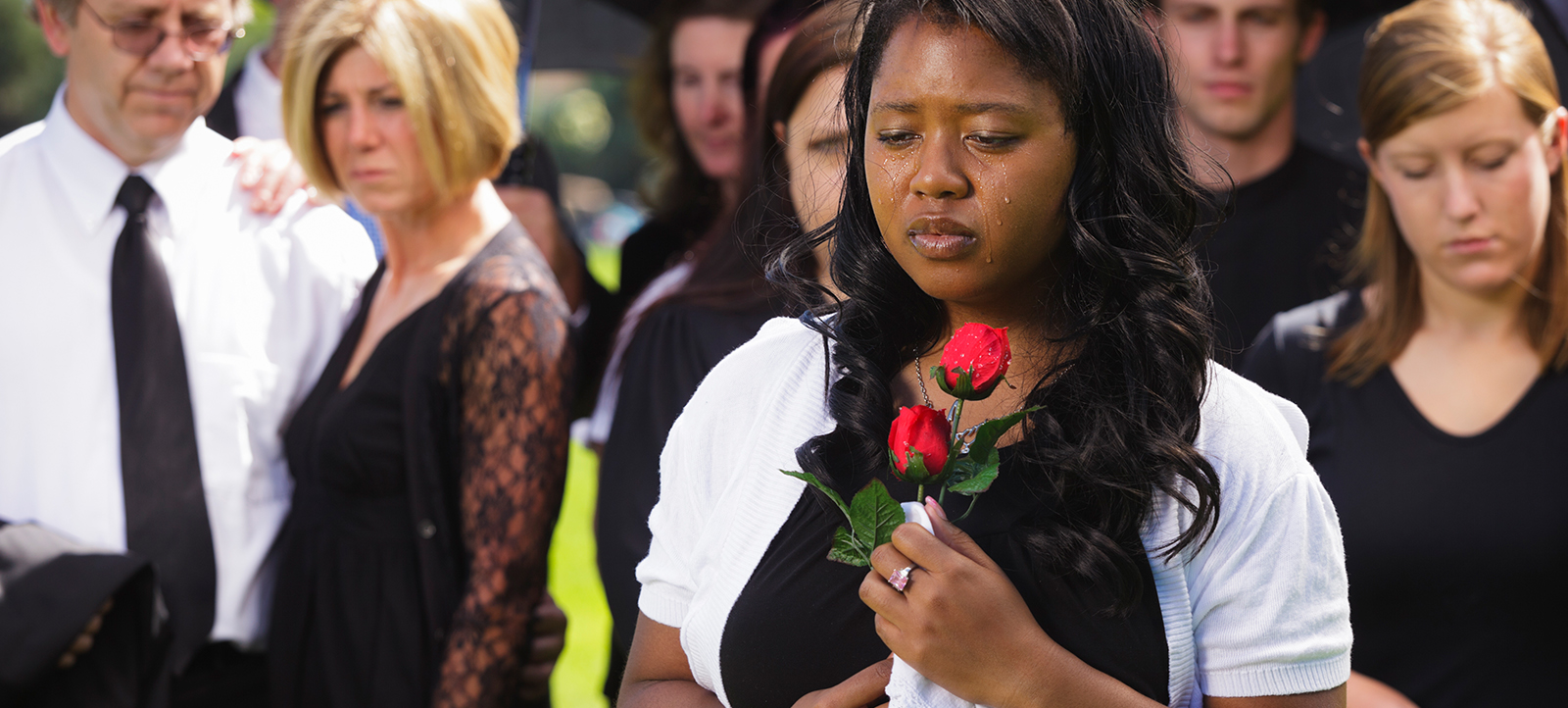 African american woman mourns on funeral after a wrongful death case.